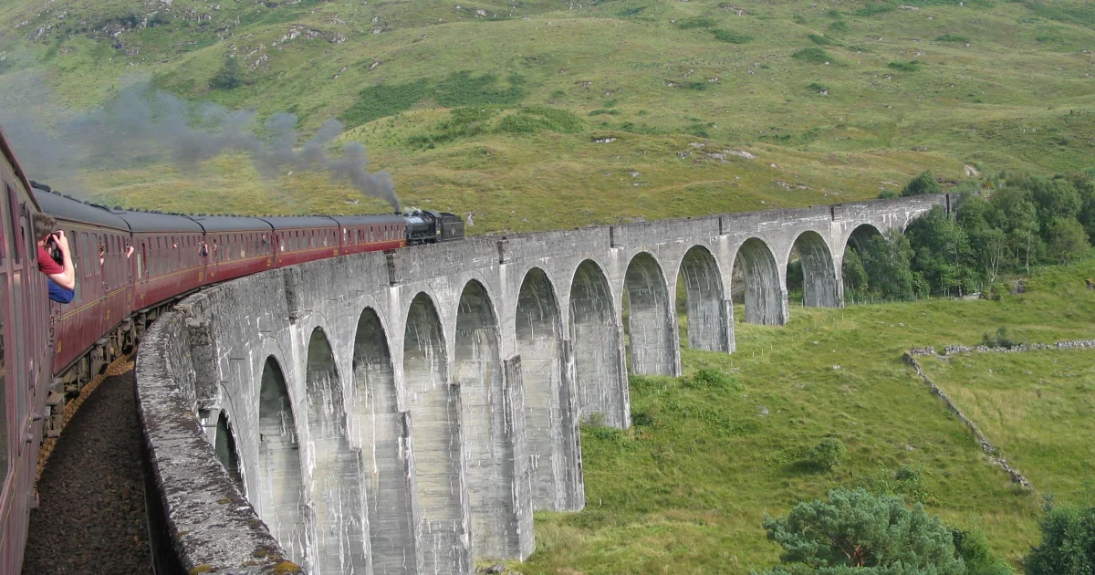 The Jacobite Steam Train crossing the Glenfinnan Viaduct, with steam rising above the arches
