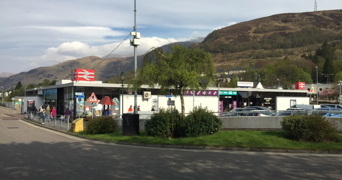Fort William railway station and travel centre with the Highland hills behind